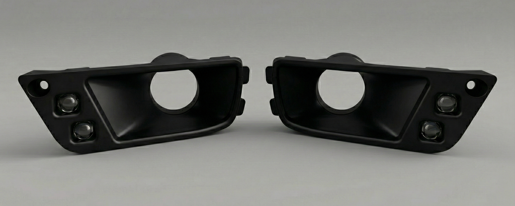 Two black automotive parts on a gray background