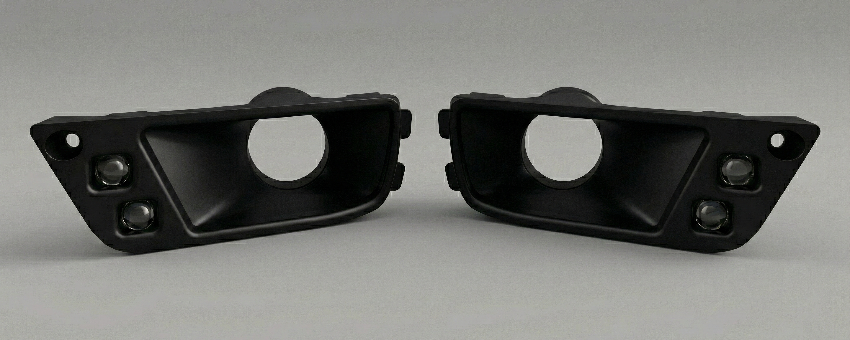 Two black automotive parts on a gray background