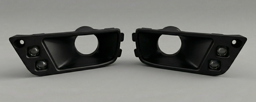 Two black automotive parts on a gray background